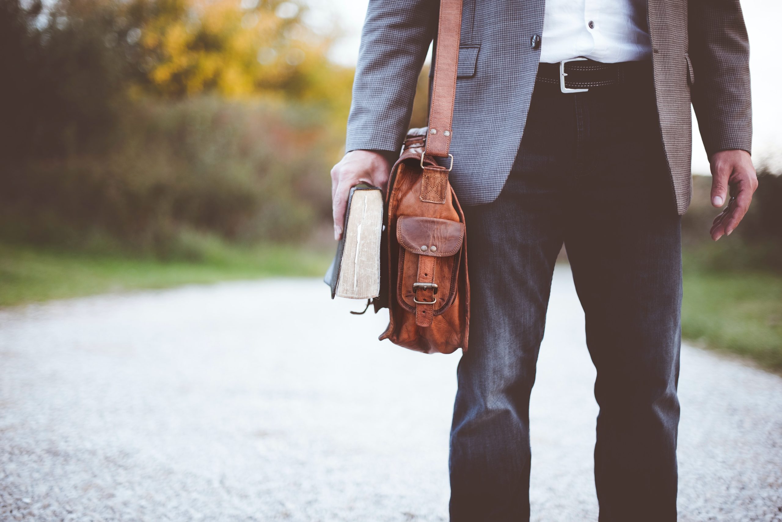 Man with book and satchel